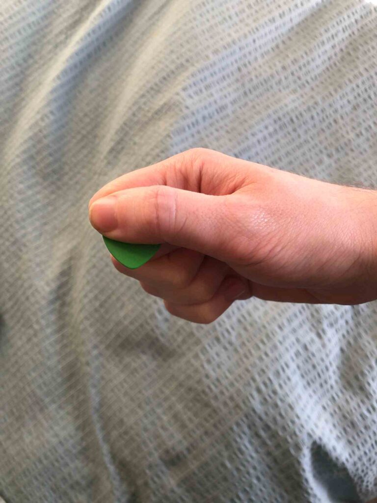 how to hold a guitar pick step 3 thumb on top
