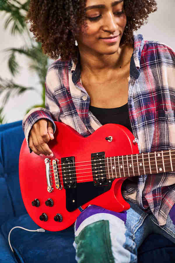 girl playing a red gibson les paul modern lite